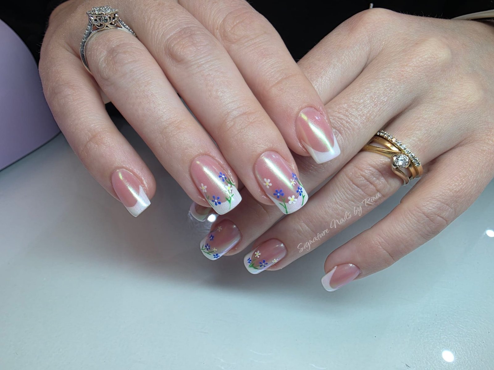 Pale pink nails with blue glitter tips