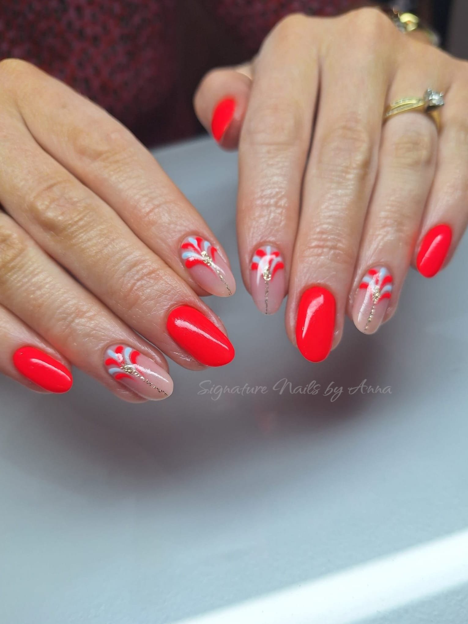 Red nails with festive snowflake and candy-cane detail