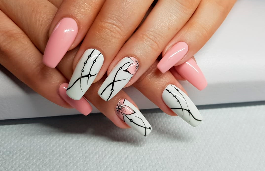 Pink and white nails with black line art