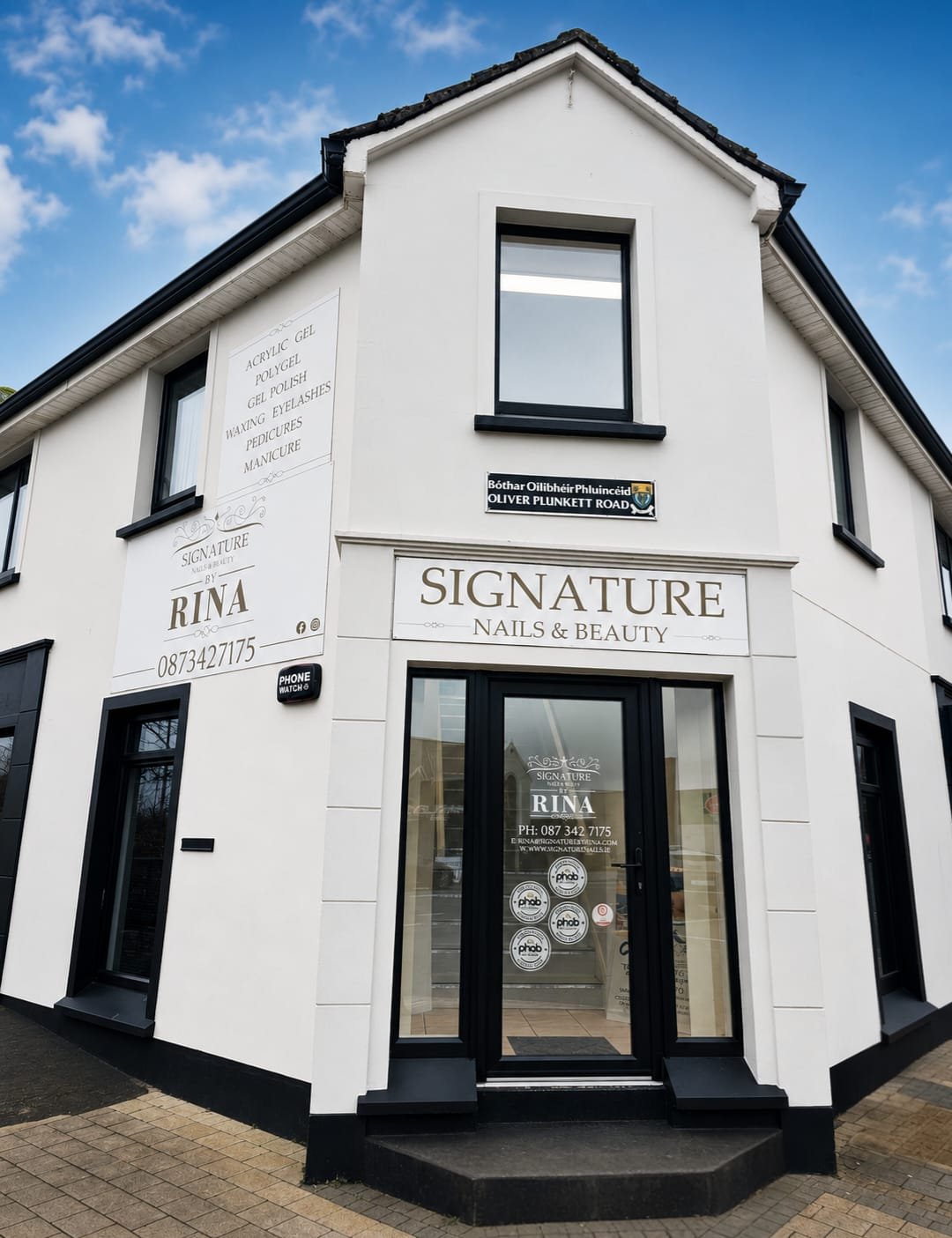 White corner building housing Signature Nails & Beauty by Rina